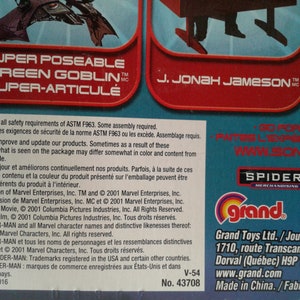 May include: A red, green, and white action figure of Green Goblin from the Spider-Man movie. The figure is super-poseable and super-articulated. The packaging also features J. Jonah Jameson and the Spider-Man logo. The figure is made by Toy Biz and is part of the Marvel Universe.