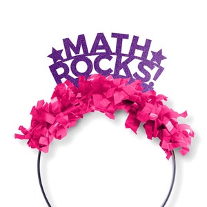 May include: Purple glitter headband with the words "MATH ROCKS!" and pink tissue paper streamers.