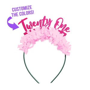 May include: Pink and black headband with the words "Twenty One" in pink glitter. The headband is decorated with pink tissue paper.