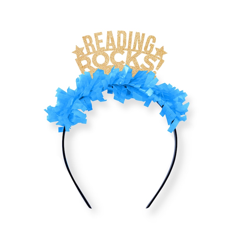 May include: A blue and gold headband with the words "Reading Rocks!" in gold glitter. The headband is decorated with blue tissue paper.
