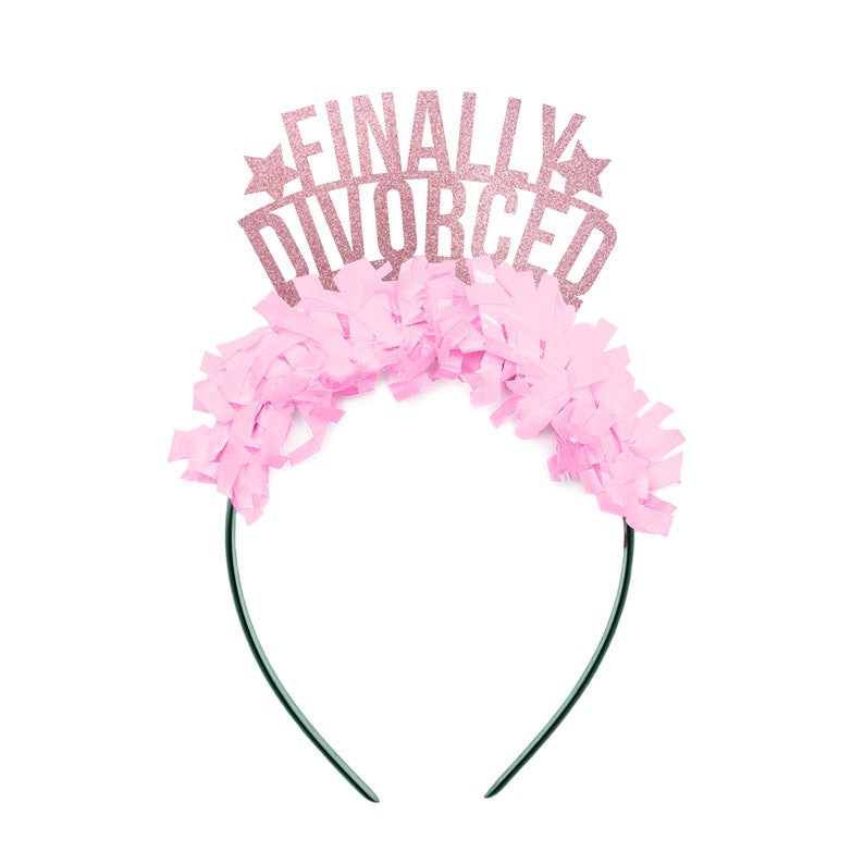 May include: Pink and gold glitter headband with the text "FINALLY DIVORCED" on it. The headband is decorated with pink tissue paper.