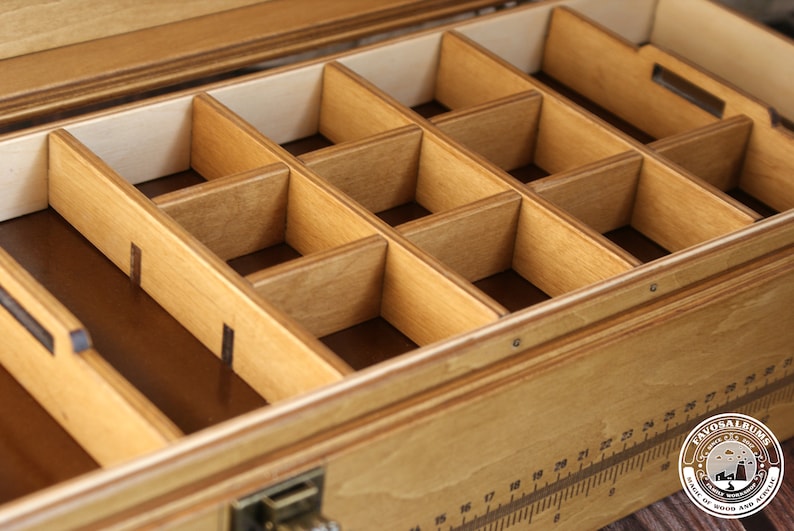 May include: A wooden box with a removable tray containing multiple compartments. The tray is made of light wood and has a natural finish. The box is made of a darker wood and has a more polished finish.