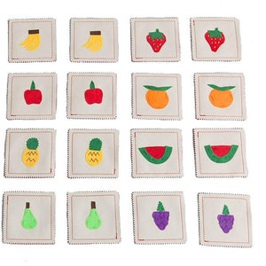 May include: A set of 12 felt squares with various fruit and vegetable images. The images include a pineapple, watermelon, strawberry, apple, pear, orange, and grape.
