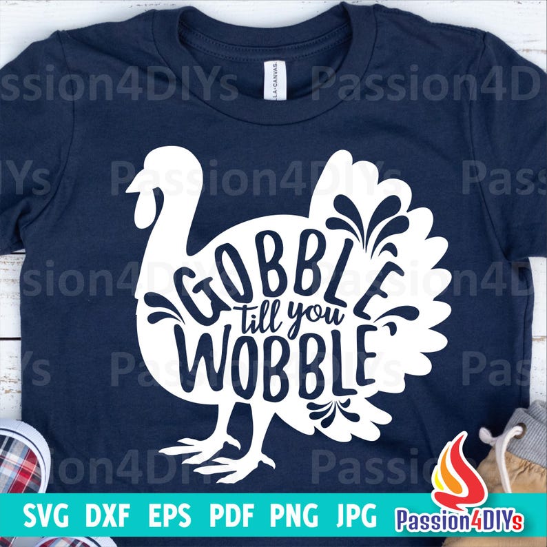 May include: A navy blue t-shirt with a white silhouette of a turkey with the text "Gobble till you wobble" inside the turkey.