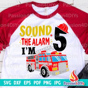 May include: A white t-shirt with a red, black, and yellow graphic of a fire truck and the text "Sound the alarm I'm 5".