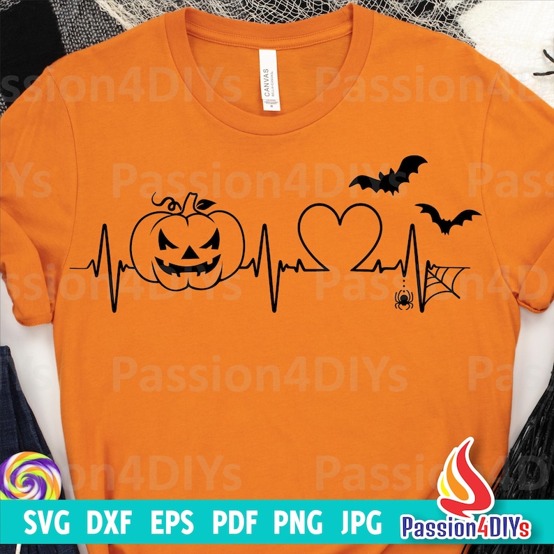 K&ouml;nnte beinhalten: Orangefarbenes T-Shirt mit einer schwarzen Grafik aus einem K&uuml;rbis, einem Herzen, Flederm&auml;usen, einer Spinne und einem Spinnennetz mit einer Herzschlaglinie. Der Text "Passion4DIYs" ist auf das T-Shirt gedruckt.