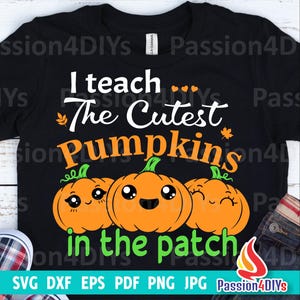 May include: Black t-shirt with a white graphic design that says "I teach the cutest pumpkins in the patch". The graphic features three cartoon pumpkins with smiling faces.