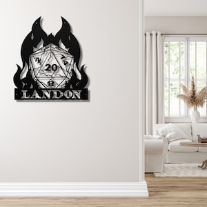 May include: Black metal wall art featuring a flaming dice with the number 20 visible and the name Landon below.