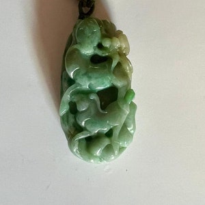 APPLE GREEN JADEITE Jade Pendant On Silk Wrapped Neck Cord.  100% natural untreated.  Intricately Carved Animals.