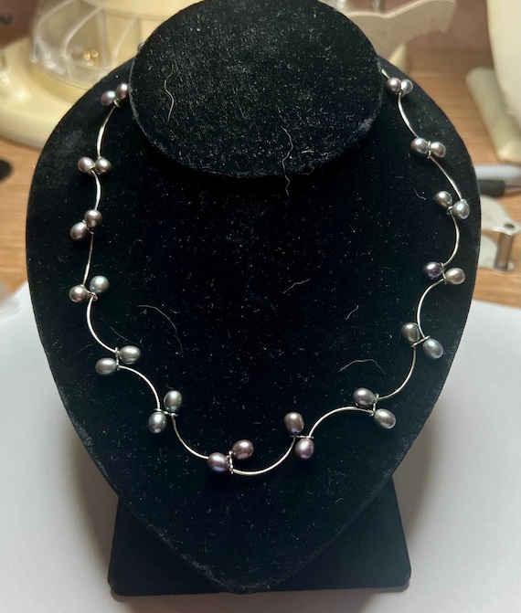 SILVER PEARL NECKLACE.  Pearls are set on silver h