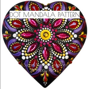 May include: A heart-shaped rock painted with a black, white, gold, red, and purple dot mandala pattern. The text "DOT MANDALA PATTERN" is at the top of the rock. The text "Susan Nelson Creations & Poppy Rocks" is at the bottom of the rock.