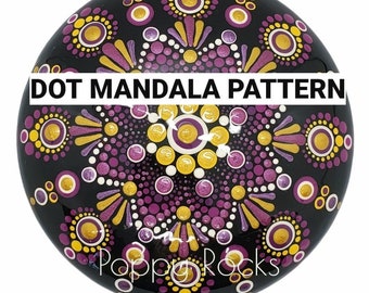 Może przedstawiać: Czarny, okrągły kamień z wzorem mandali z fioletowych, białych i złotych kropek. Tekst "DOT MANDALA PATTERN" jest napisany na górze kamienia. Tekst "Poppy Rocks" jest napisany na dole kamienia.