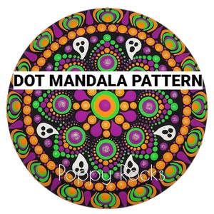 May include: A black, orange, green, and purple dot mandala pattern with white ghost shapes. The mandala is painted on a round rock with the words "DOT MANDALA PATTERN" and "Poppy Rocks" in white.