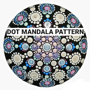 May include: A black rock painted with a colorful dot mandala pattern. The pattern features white, blue, pink, and purple dots arranged in a circular design. The text "DOT MANDALA PATTERN" is written across the top of the rock.