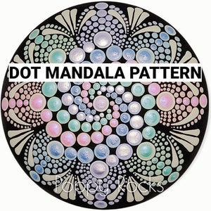 May include: A black stone painted with a colorful dot mandala pattern. The pattern features a spiral of pink, blue, green, and white dots. The text "DOT MANDALA PATTERN" is written across the top of the stone.