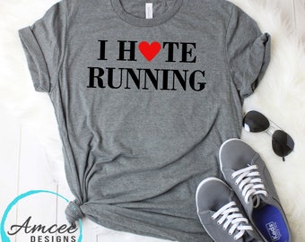 May include: Gray t-shirt with the text "I ♥ TE RUNNING" in black lettering. The heart is red.