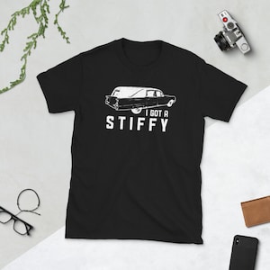 May include: Black t-shirt with a white graphic of a hearse and the text "I got a stiffy".