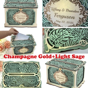 May include: A wooden wedding card box with a light sage green and gold design. The box has a cutout design of tropical leaves and the text "Tiffany & Brandon Ferguson May 22, 2025".