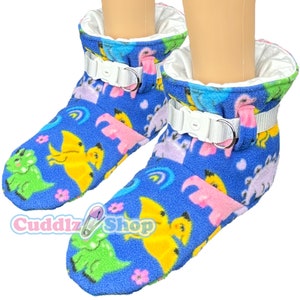 May include: Blue fleece booties with a dinosaur print and white adjustable straps. The booties are lined with white fleece.