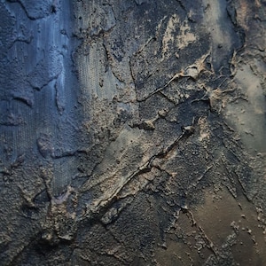 May include: A close-up of a textured, dark blue and gold surface. The surface has a rough, uneven texture, with deep cracks and crevices. The colors are muted and blend together seamlessly, creating a sense of depth and dimension.
