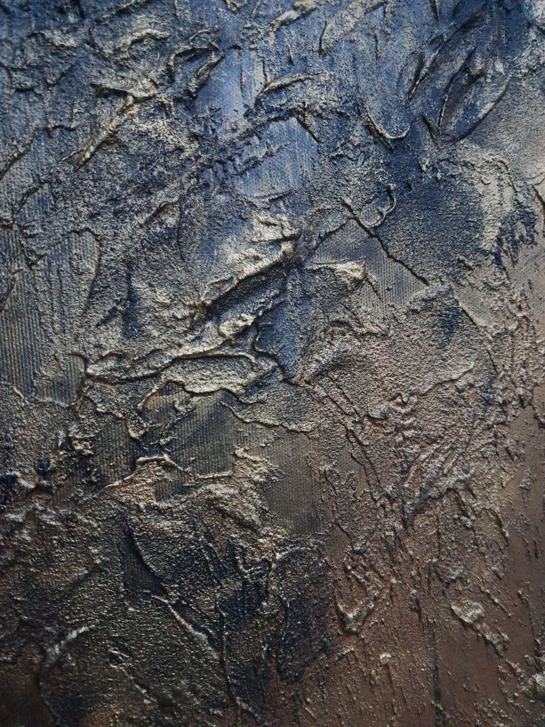 May include: A textured, abstract painting with a dark blue and gold color scheme. The paint has been applied in a thick, impasto style, creating a three-dimensional effect.
