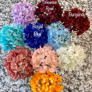 May include: Assortment of ten artificial hydrangea flower heads in various colors, including lilac, cinnamon rose, burgundy, tiffany, royal blue, blue, dusty rose, pink, white, and orange.
