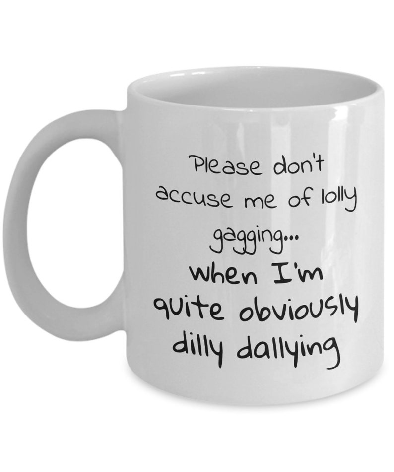 May include: White ceramic coffee mug with black text that reads "Please don't accuse me of lolly gagging... when I'm quite obviously dilly dallying."