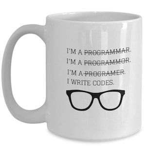 May include: White ceramic coffee mug with black text that reads "I'M A PROGRAMMAR. I'M A PROGRAMMOR. I'M A PROGRAMER. I WRITE CODES." and a pair of black eyeglasses.
