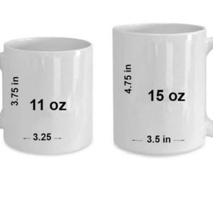 May include: Two white ceramic mugs with black text. The smaller mug is 11 oz and 3.75 inches tall. The larger mug is 15 oz and 4.75 inches tall.