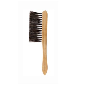 May include: A wooden brush with dark bristles. The handle is a light brown color and has a curved design for easy grip. The bristles are densely packed and appear to be made of natural fibers. This brush is likely used for cleaning or grooming.