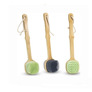 May include: A white ceramic mug with a black handle and the text "But First, Coffee" in a bold, black font. The mug is set against a blurred background, suggesting a cozy setting.