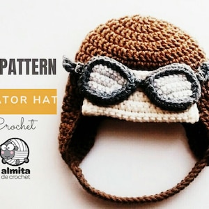 May include: A crocheted aviator hat in brown with attached goggles. The goggles are gray and white, and the hat has ear flaps. The text "PDF PATTERN AVIATOR HAT Crochet" is visible on the left side of the image.