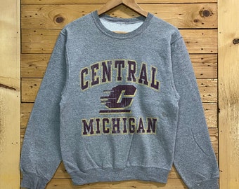 May include: Gray sweatshirt with a vintage-style graphic print of "CENTRAL MICHIGAN" in yellow and maroon lettering. The graphic includes a stylized letter "C" with a maroon lightning bolt.