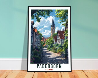 Könnte beinhalten: Ein gerahmtes Reiseplakat mit einer Straßenszene in Paderborn, Deutschland. Die Illustration zeigt Fachwerkhäuser, einen hohen Kirchturm, grüne Bäume und einen blauen Himmel mit Wolken. Der Text PADERBORN GERMANY steht am unteren Rand.