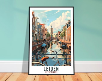 May include: A framed art print of Leiden, Netherlands, featuring a canal scene with buildings, boats, and a bicycle in the foreground. The artwork has a vibrant color palette with a blue sky and water, and the text "LEIDEN NETHERLANDS" at the bottom.