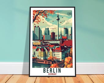 May include: A framed art print depicting a stylized illustration of Berlin, Germany. The artwork shows the city's skyline with the TV Tower, buildings, and colorful rooftops. The print includes the text "BERLIN GERMANY" at the bottom.