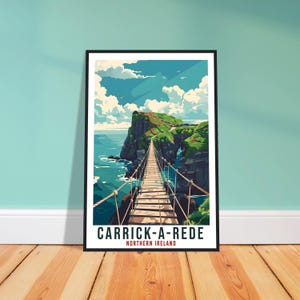 May include: A framed art print of Carrick-a-Rede in Northern Ireland. The image depicts a wooden rope bridge spanning a gap between two cliffs, with the ocean and sky in the background. The print has a black frame and the text "CARRICK-A-REDE NORTHERN IRELAND".