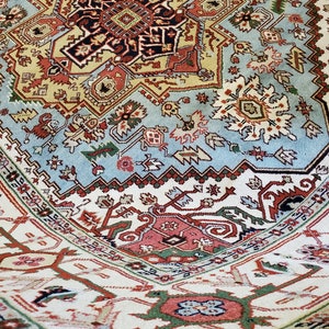 May include: A detailed, colorful rug with a central medallion and intricate geometric patterns. The rug features shades of blue, red, green, and white.