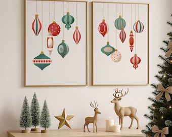 May include: Two framed prints with gold borders feature watercolor Christmas ornaments in red, green, and white. A wooden cabinet displays miniature Christmas trees, a gold star, and deer figurines. A decorated Christmas tree is in the background.