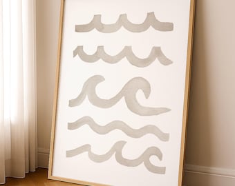 May include: A framed art print featuring a minimalist design of stylized waves in shades of gray against a white background. The artwork is encased in a natural wood frame, creating a coastal or nautical theme. The print is displayed on a wooden floor.