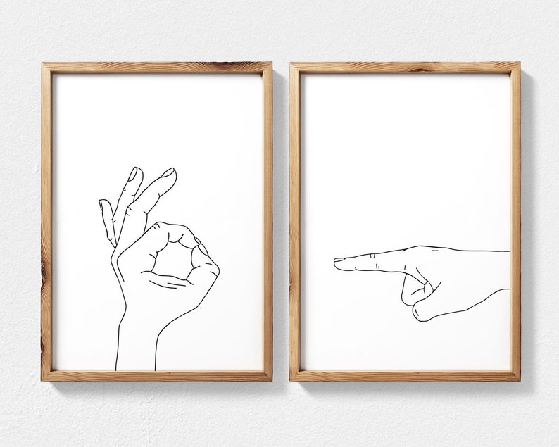 Puede incluir: Dos impresiones enmarcadas con dibujos de l&iacute;neas negras de manos haciendo gestos. La impresi&oacute;n de la izquierda muestra una mano haciendo el signo de OK. La impresi&oacute;n de la derecha muestra una mano apuntando hacia la derecha.