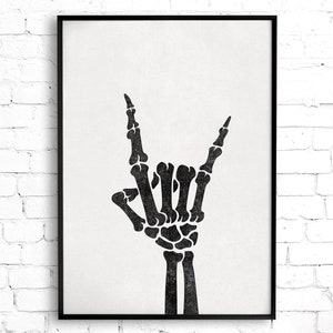May include: Black and white illustration of a skeleton hand giving the rock and roll hand gesture.
