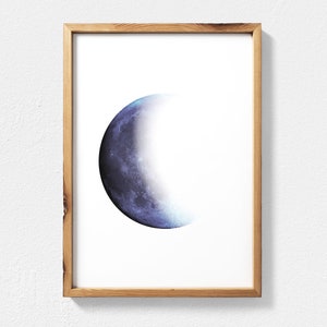 May include: A framed print of a crescent moon with a blue and purple watercolor effect.