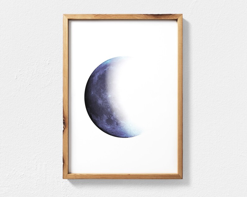 May include: A framed print of a crescent moon with a blue and purple watercolor effect.