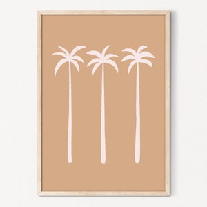 May include: A framed print with a minimalist design featuring three pink palm trees on a light brown background.