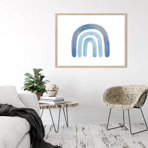 May include: A watercolor painting of a blue rainbow on a white background. The rainbow is made up of three arches, each a different shade of blue.