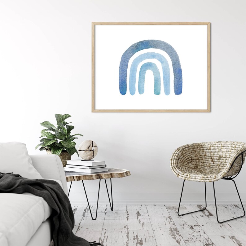 May include: A watercolor painting of a blue rainbow on a white background. The rainbow is made up of three arches, each a different shade of blue.