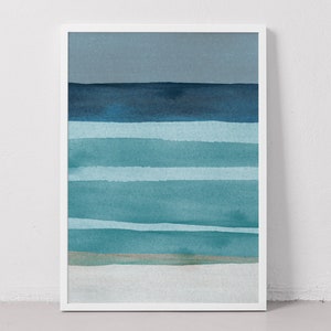 May include: Abstract watercolor painting of a seascape with blue and teal stripes representing waves and a light blue sky. The painting is framed in a white frame.