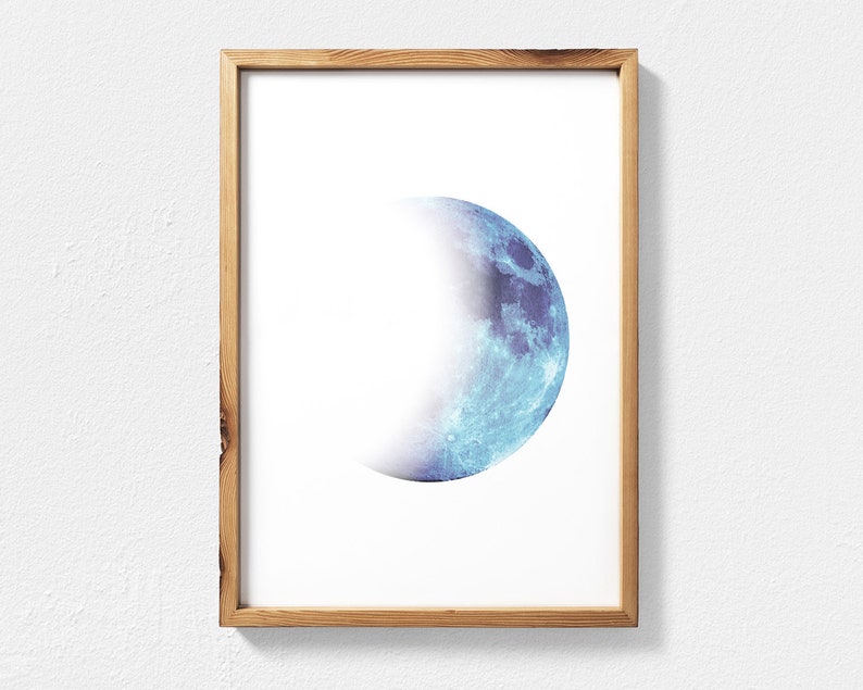 May include: A framed print of a blue and white crescent moon on a white background.