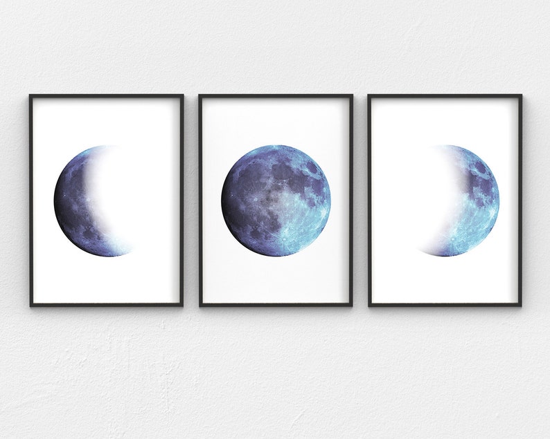 May include: Three framed prints of the moon in different phases. The moon is a blue and white color. The frames are black.